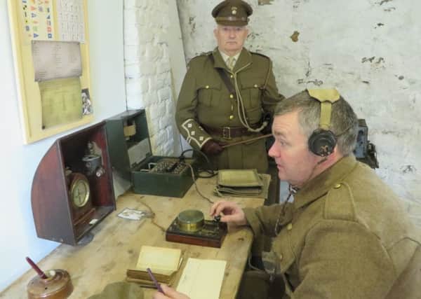 Radio operator Tony Watson and Brian Johnston re-enact the receiving of historic morse code message in Enniskillen Barracks