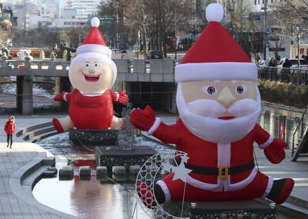 Huge installations of Santa Claus are displayed during the Seoul Christmas Festival, South Korea, in December 2017