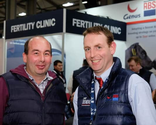 Genus RMS customer David Conn, left, from Castlerock, discussing cow fertility with James Woods, Genus ABS on the Genus ABS stand at the Royal Ulster Winter Fair. Photograph: Columba O'Hare/ Newry.ie
