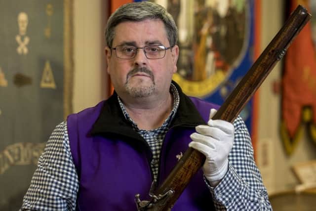 Dr Jonathan Mattison, curator of the Museum of Orange Heritage in Belfast holding the 'Boyne Musket', a dragoon carbine used by a Jacobite officer during the War in Ireland between 1688 and 1691