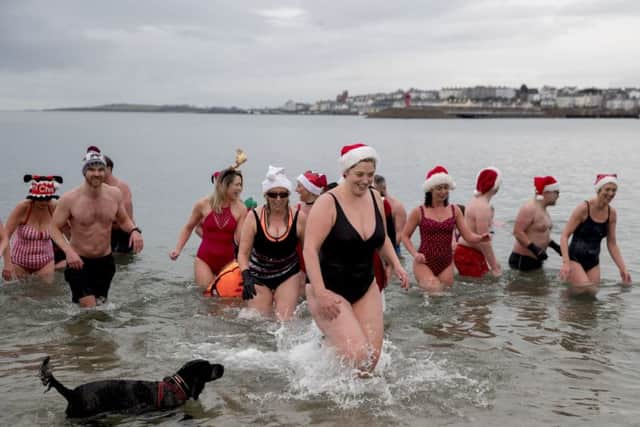 Team Dash and Splash swimmers, some in fancy dress, after a swim in the Irish Sea at Bangor beach. Photo: Liam McBurney/PA Wire