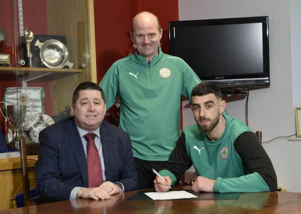 Cliftonville goal machine Joe Gormley pictured at Solitude with Chairman Gerard Lawlor and manager Barry Gray after penning a three year extension to his current contract