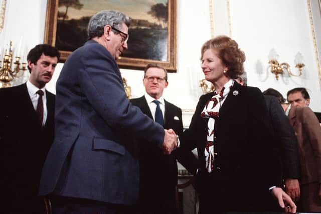 Margaret Thatcher, with her then Secretary of State Tom King in the background, centre, at the signing of the Anglo-Irish Agreement in 1985