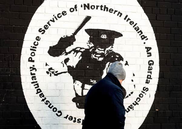 A man walking past an Irish Republican mural in west Belfast. Photo: Liam McBurney/PA Wire
