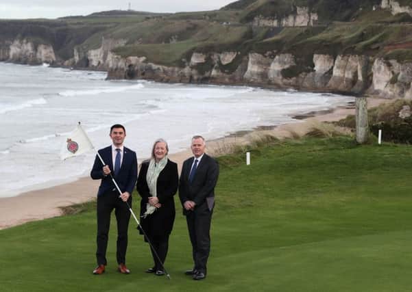 Mike Woodcock (left), Head of Corporate Communications at the R&A, Aine Kearney, Tourism NI, and John Bamber (right), Chairman of the 148th Open Championship committee at Royal Portrush, on the 6th green of the course at Royal Portrush Golf Club in Co. Antrim. The organisers of golf's Open Championship have said they are staggered by the level of interest in the tournament's historic return to Northern Ireland. Pic: Brian Lawless/PA Wire