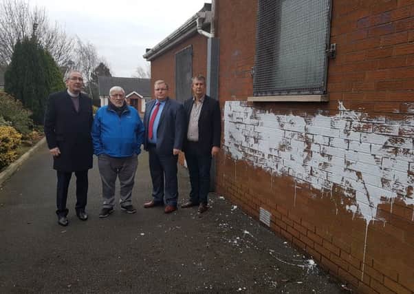 Rev Alan Smylie, Billy Smyth, chairman of the Seymour Hill and Conway Community Association, DUP councillor Jonathan Craig and Edwin Poots MLA at the scene of a graffiti attack at Dunmurry Free Presbyterian Church.