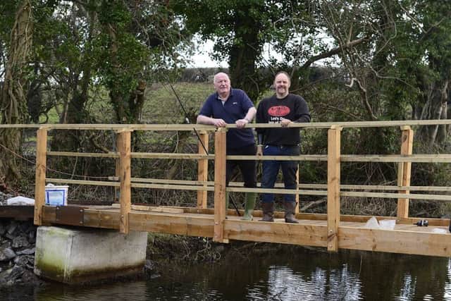 Nigel Cree and Robert Maxwell standing on the bridge they built at the fishing retreat.
 Picture by Arthur Allison Pacemaker.