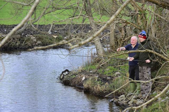 Our reporter gets some fishing tip from ex-serviceman Nigel Cree. 
Picture by Arthur Allison Pacemaker.