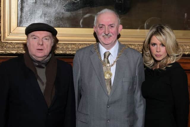 Dr Ian Adamson OBE (centre) and his wife Kerry pictured at Belfast City Hall with singer Van Morrison in 2011. Pic by Presseye