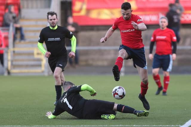 Glenn Irwin is tackled by Gary Dunlop in the charity football match at Seaview.