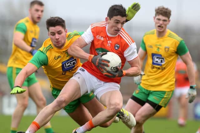 Armagh's Rory Grugan with Donegal's Brendan McCole and Conor Morrison