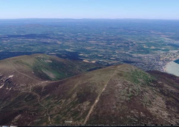 Slieve Commedagh (about 765m, or 2,510ft) is pictured in the centre left of this image, with Newcastle behind in the distance and Slieve Donard to the right (at about 850m, or 2,789m). Image taken from Google Maps.