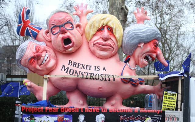 An effigy of Prime Minister Theresa May, former foreign secretary Boris Johnson, current Environment Secretary Michael Gove and former Brexit secretary David Davis, is driven past the Houses of Parliament