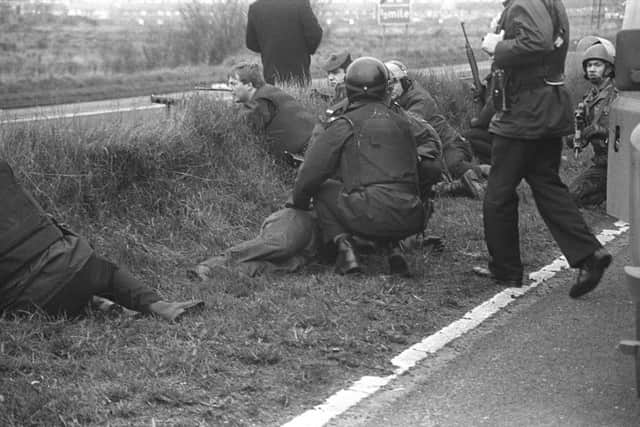 Michael Stone is rescued by RUC officers on the M1 motorway after his graveyard attack