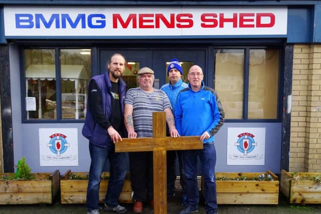 Ballybeen Men's Shed with wooden cross. Peter McCabe on left and John Laverty of Ballybeen Mens Motivation Group on right