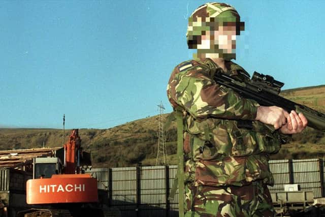 A British soldier stands guard for the last time at Fort Whiterock Army Base in West Belfast in 1999 as bulldozers moved in to dismantle the remains of the 20 year-old base which had been home to more than 7,500 troops and witnessed some of the worst of the Troubles. (Photo: Pacemaker)