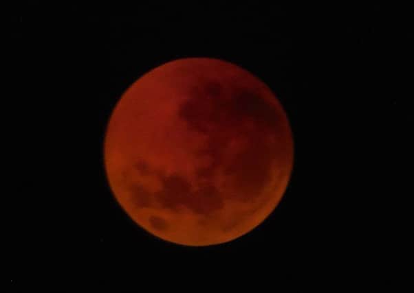 The moon can appear a dark orange or red colour during a total lunar eclipse.