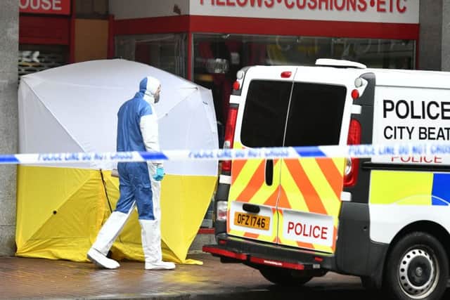 Police officers investigating the sudden death of a man at High Street in Belfast city centre. The male, thought to be a rough sleeper aged in his mid to late 20s, was found in a shop doorway on Friday morning. Pic: Colm Lenaghan/Pacemaker Press