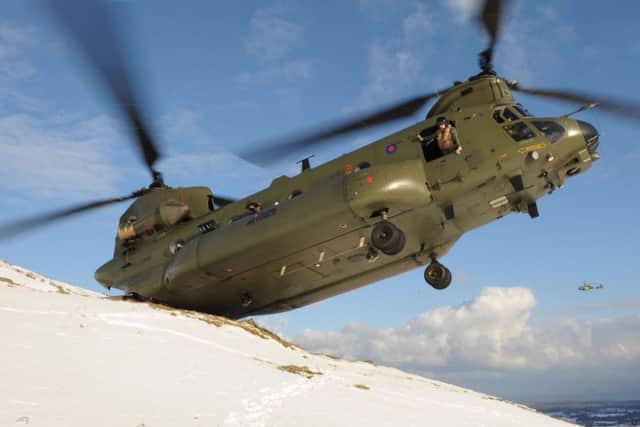 An Army Chinook helicopter delivers aid to farms in the South Down area of Northern Ireland in 2013