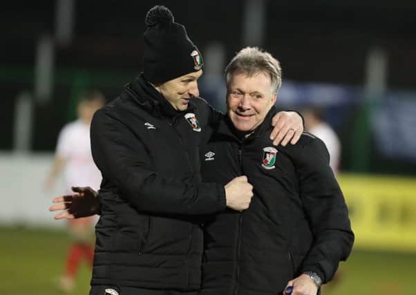 Celebration time for Paul Leeman (left) and Kieran Harding of the Glentoran backroom team following Saturday's success against Newry City AFC. Pic by Pacemaker.