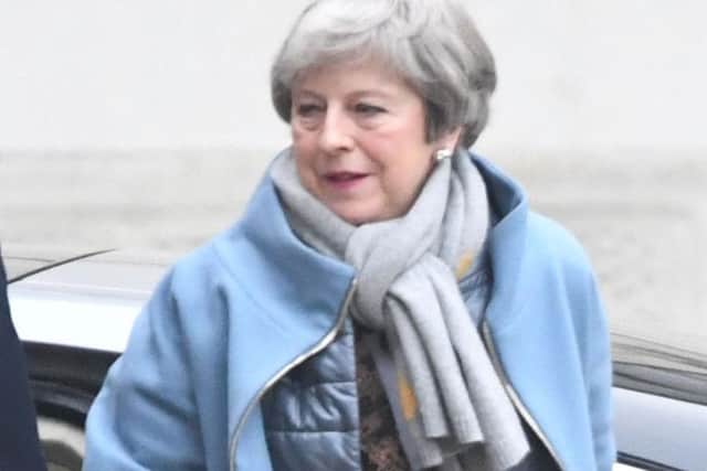 Prime Minister Theresa May arrives back at 10 Downing Street in London ahead of making a statement on her new Brexit motion in the House of Commons.