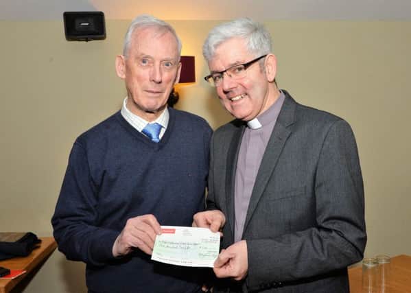 Rev Dr Ivan Hull presents a cheque for £200 on behalf of the Larne Tuesday Club to the Very Rev Stephen Forde, Dean of St Anne's Cathedral Belfast, for his Black Santa Appeal. INLT 02-002-PSB