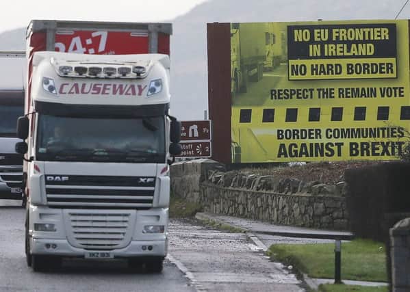 A truck passes a Brexit billboard in Jonesborough, Co Armagh, on the northern side of the border between Northern Ireland and the Republic of Ireland. Pic by Niall Carson/PA Wire