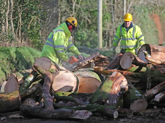 Workmen making safe the scene in Clough