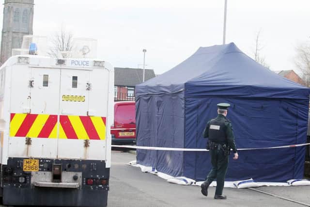 Police at the scene of the murder at Cluan Place, east Belfast