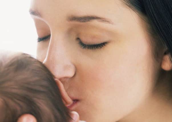 Young Mother Kissing Infant