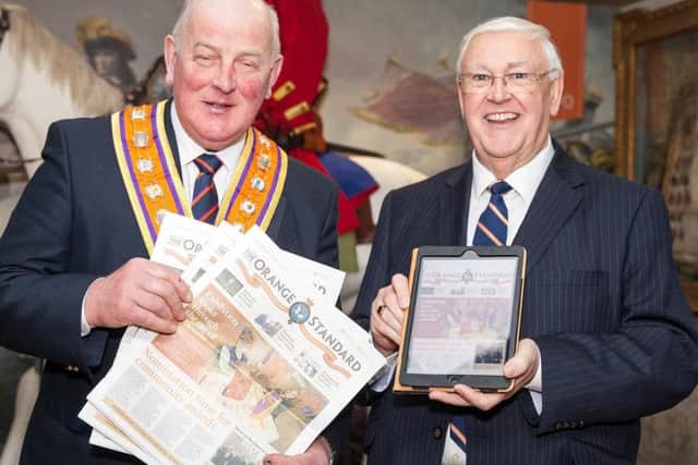 Grand Master Edward Stevenson (left) and Tom Haire, chairman of the Orange Standard committee, show off the loyal order's new-look newspaper which was launched at Schomberg House yesterday