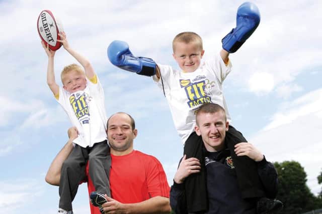 Ulster Rugby star Rory Best and Olympic boxer Paddy Barnes celebrating with Paul McConville and Jake McGarrigle from Round Tower Integrated Primary School, who are part of the winning key stage one class to be crowned inaugural Fit Factor Champions 2009, an Ulster Cancer Foundation initiative. Photography by Kelvin Boyes
