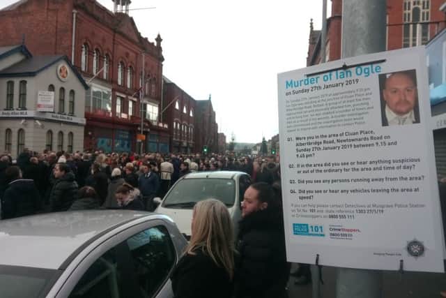 The funeral procession makes its way along Albertbridge Road towards Templemore Avenue, past a poster appealing for information about the murder.