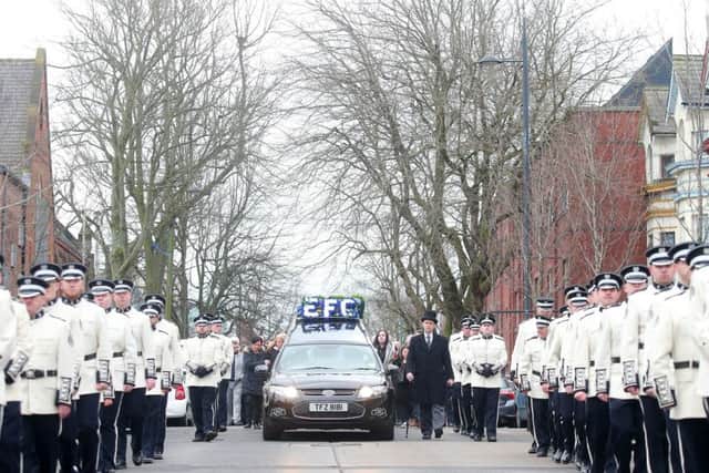 Ian Olge's coffin makes its way down Templemore Avenue after his funeral service, flanked by members of the East Belfast Protestant Boys Flute Band. 

Picture by Jonathan Porter/PressEye