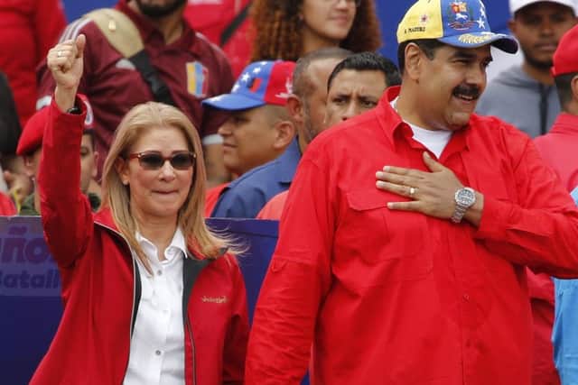 Venezuela's President Nicolas Maduro and first lady Cilia Flores acknowledge supporters at the end of a rally in Caracas, Venezuela last Saturday