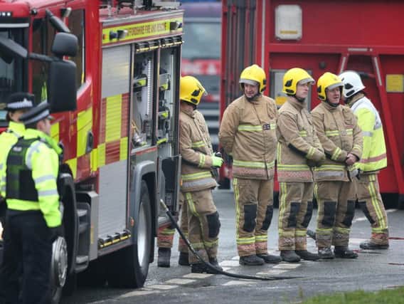 Firefighters at the scene of a house fire in Sycamore Lane, Stafford, which claimed the lives of four children.