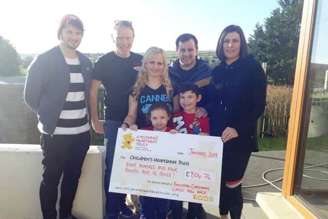 Race organisers, Stephen, Dale, Laura, Gareth and Hazel are pictured with a cheque for Childrens Heartbeat Trust totalling £804.76. Included is Rosie who has been supported by the charity and her brother PJ.