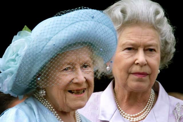 Queen Elizabeth (L), the Queen Mother celebrates her 100th birthday from the balcony of Buckingham Palace with her daughter Queen Elizabeth II, as thousands of people flocked to the streets outside the Palace to cheer the Queen Mother.