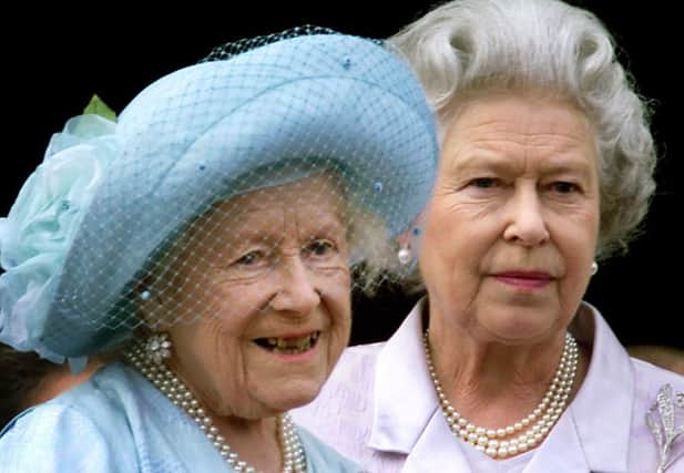 Queen Elizabeth (L), the Queen Mother celebrates her 100th birthday from the balcony of Buckingham Palace with her daughter Queen Elizabeth II, as thousands of people flocked to the streets outside the Palace to cheer the Queen Mother.