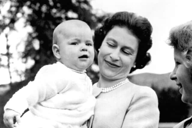 The Queen holding Prince Andrew during an outing in the grounds at Balmoral, Scotland, where the Royal Family are on holiday.