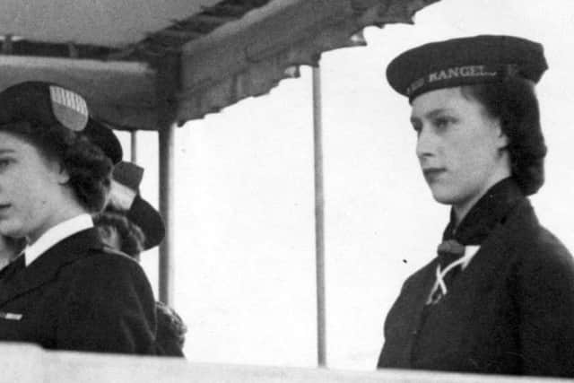 Princess Elizabeth (later Queen Elizabeth II), in her uniform of Sea Ranger, and Princess Margaret (right), at a drumhead service and march past by Girl Guides in London's Hyde Park.