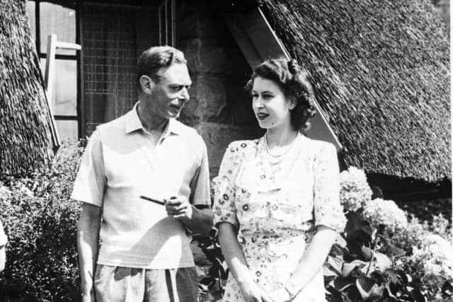 An informal picture of King George VI relaxing with his daughter Princess Elizabeth during a visit to Natal National Park in South Africa.