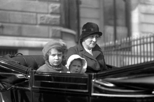 Princess Elizabeth (left, later Queen Elizabeth II) and her sister Princess Margaret Rose out for a ride with their nanny in their horse-drawn carriage, in 1933.