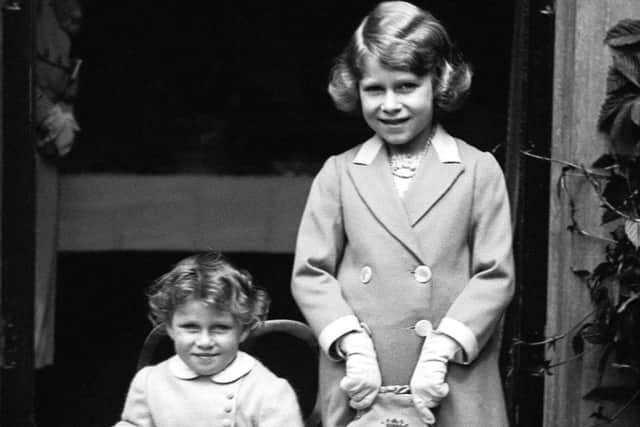 Two-year-old Princess Margaret (seated) with her sister Princess Elizabeth, aged seven.