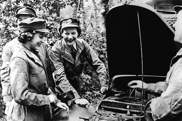 Princess Elizabeth receives vehicle maintenance instruction on an Austin 10 Light Utility Vehicle while serving with No 1 MTTC at Camberley, Surrey.