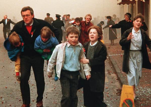 Terrified men, women and children flee the IRAs 1987 Poppy Day bomb in Enniskillen, which used Semtex supplied by former Libyan dictator Col Gaddafi