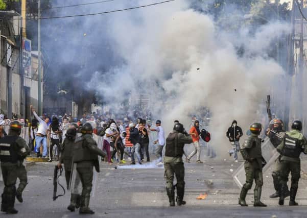 Riot police clash with opposition demonstrators during a protest against the government of President Maduro January 23, 2019