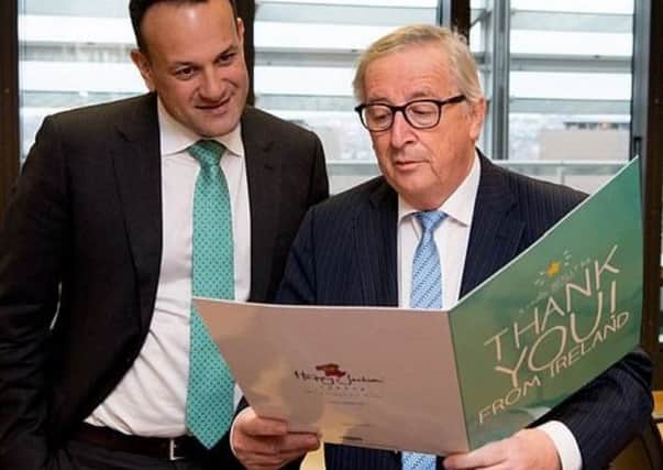 Taoiseach Leo Varadkar and European Commission president Jean-Claude Juncker read a giant 'thank-you' card from an Irish woman