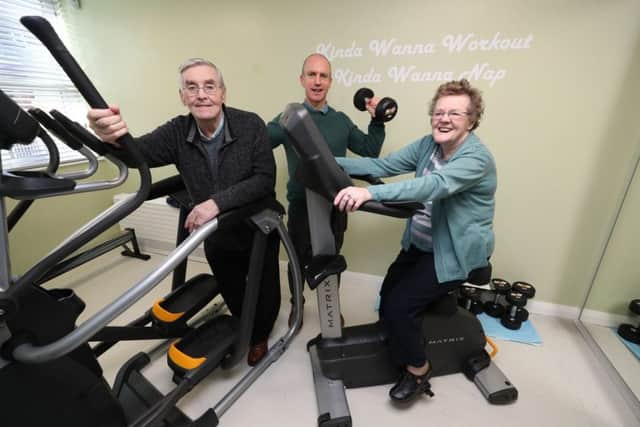 (left to right) Joe Gillen, Fitness coach Micky McGurn and Marie Smyth try out some gym equipment at the opening of the Springfield Charitable Association's Youth club for older people in a once derelict building on Cupar Street, Belfast. PRESS ASSOCIATION Photo. Picture date: Thursday February 7, 2019. See PA story ULSTER Cupar. Photo credit should read: Niall Carson/PA Wire