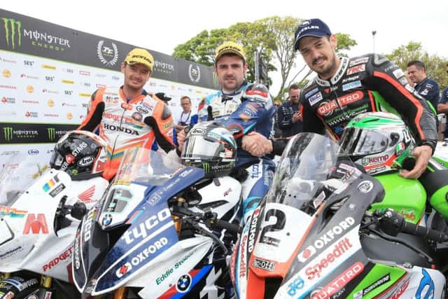 Ballymoney man Michael Dunlop celebrates his victory in the 2018 Superbike TT with James Hillier (right) and Conor Cummins (left).
